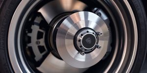 Porsche Macan with new brake pads and rotors visible.